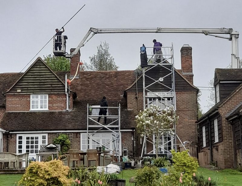 The Roof Moss Cleaners using cherry picker and scaffolding to clean roof safely and professionally in Wokingham, Berkshire